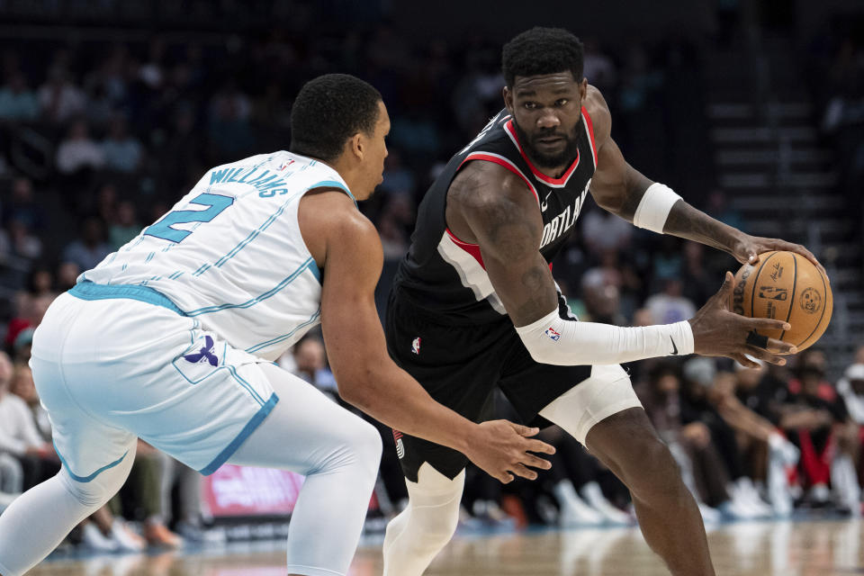 Charlotte Hornets forward Grant Williams (2) guards Portland Trail Blazers center Deandre Ayton (2) during the second half of an NBA basketball game Wednesday, April 3, 2024, in Charlotte, N.C. (AP Photo/Jacob Kupferman)