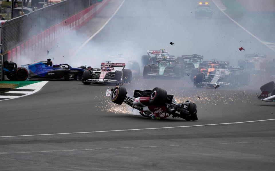 Alfa Romeo driver Guanyu Zhou of China crashes at the start of the British Formula One Grand Prix at the Silverstone circuit, in Silverstone, England, Sunday, July 3, 2022. - AP