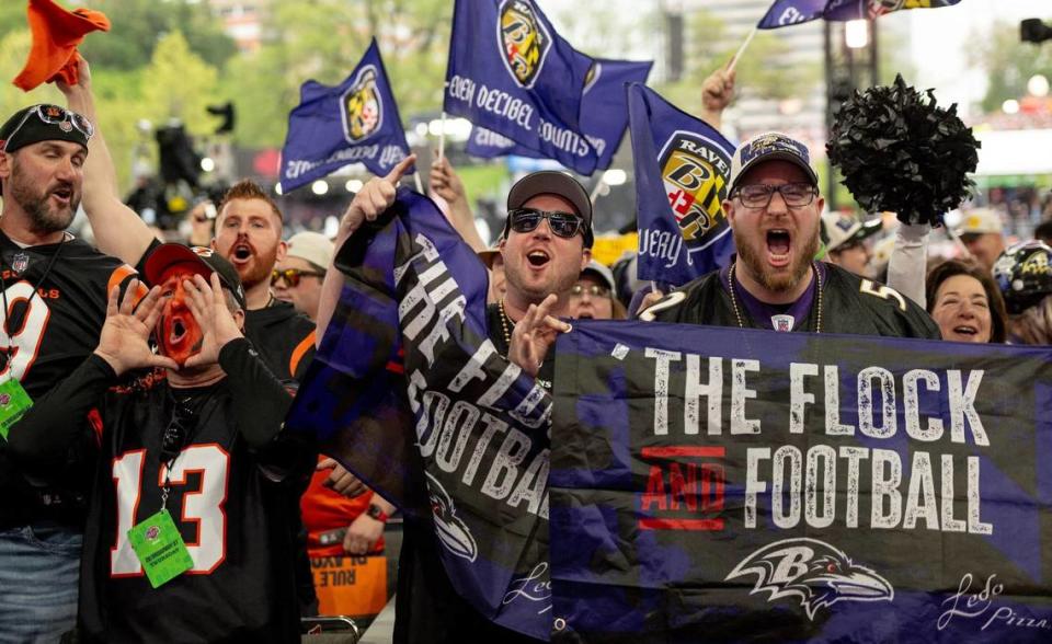 Baltimore Ravens and Cincinnati Bengals fans cheer during the NFL Draft outside of Union Station on Thursday, April 27, 2023, in Kansas City.
