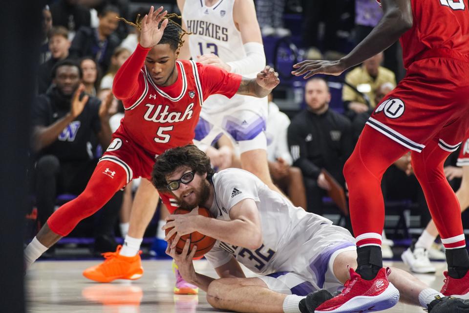 Washington forward Wilhelm Breidenbach (32) retrieves the ball next to Utah guard Deivon Smith (5) during the first half of an NCAA college basketball game Saturday, Jan. 27, 2024, in Seattle. Washington won 98-73. | Lindsey Wasson, Associated Press