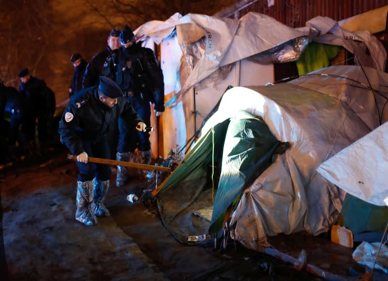 French police clear out migrants from an illegal camp in north Paris