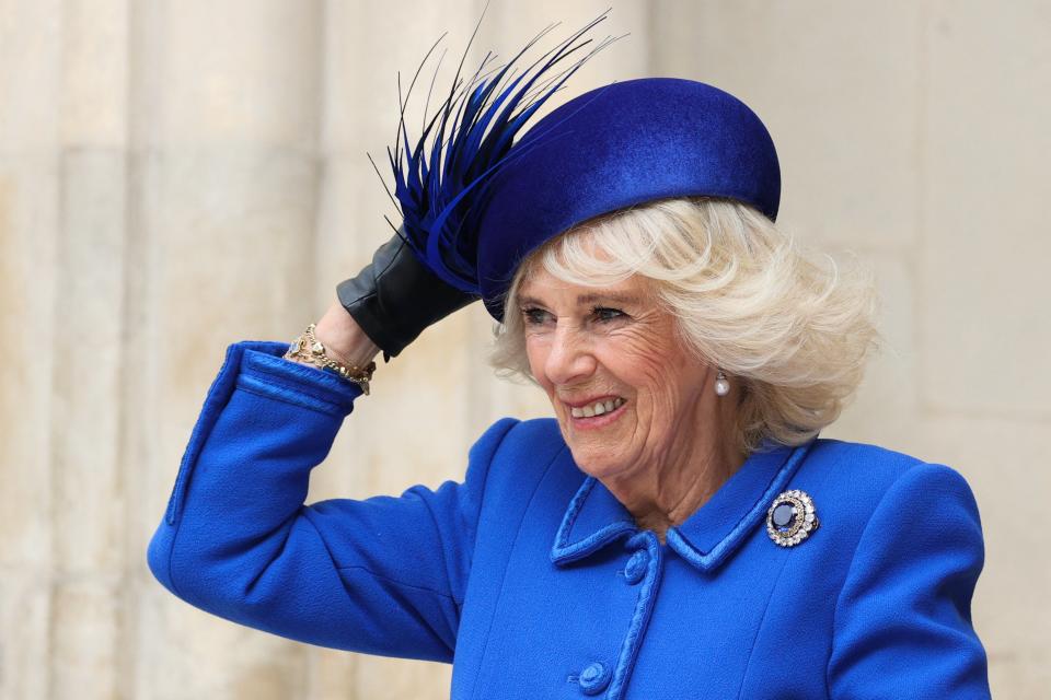 Camilla, Queen Consort holds her hat as she arrives at Westminster Abbey, in London, on March 13, 2023 to attend the Commonwealth Day service ceremony (AFP via Getty Images)