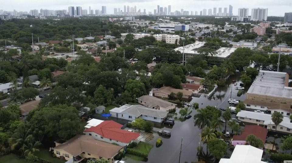 This aerial view taken from video shows a flooded street in Northeast Miami-Dade County, Fla., on Thursday, June 13, 2024. A tropical disturbance brought a rare flash flood emergency to much of southern Florida the day before. Floridians prepared to weather more heavy rainfall on Thursday and Friday. (AP Photo/Daniel Kozin)