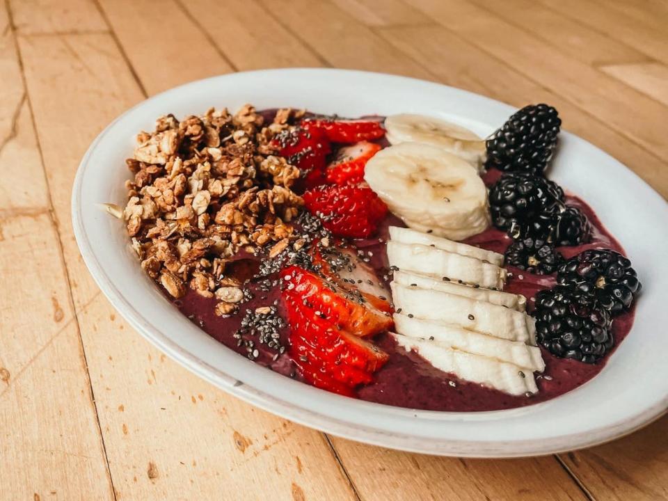 smoothie bowl with granola, chia seeds, strawberry, banana, and blackberries