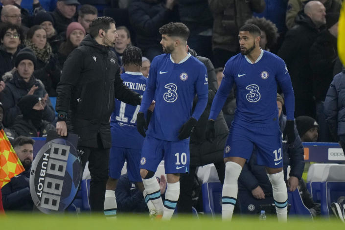 Chelsea's Christian Pulisic, (10), and Chelsea's Ruben Loftus-Cheek (12), prepare to come on as substitutes during the Champions League round of 16 second leg soccer match between Chelsea FC and Borussia Dortmund at Stamford Bridge, London, Tuesday, March 7, 2023. (AP Photo/Alastair Grant)