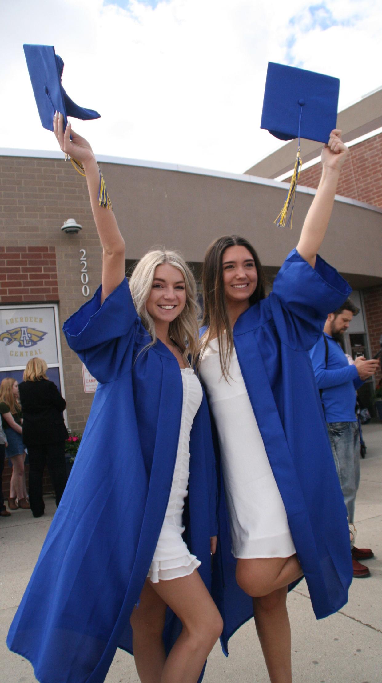 Central  High School seniors Gabby Schmierer, left, and Margo Bertsch celebrate in front of the school after graduating Sunday afternoon.