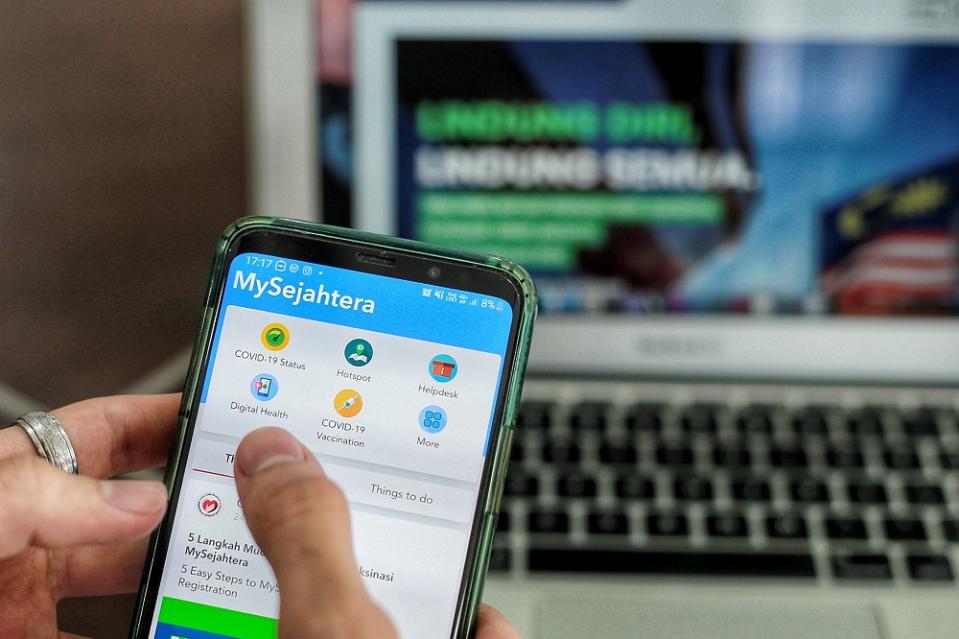 The section for Covid-19 vaccination registration via the MySejahtera mobile application is displayed on a mobile phone in Kuala Lumpur February 24, 2021. —Picture by Ahmad Zamzahuri