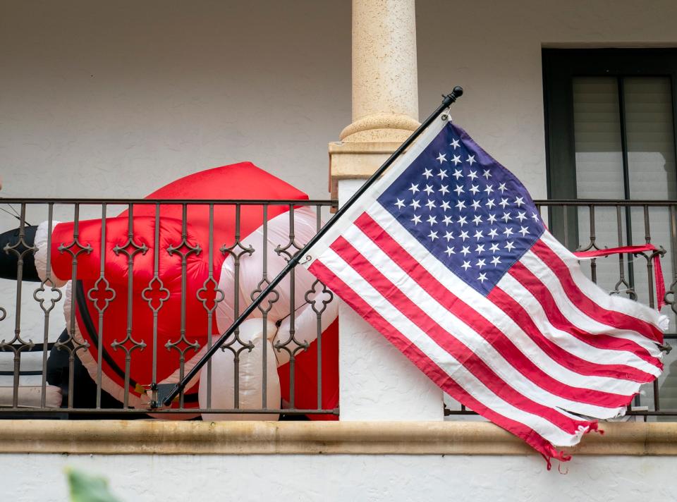 An inflated Santa Claus is toppled by the wind on a balcony at a home in West Palm Beach, Florida on December 14, 2023.