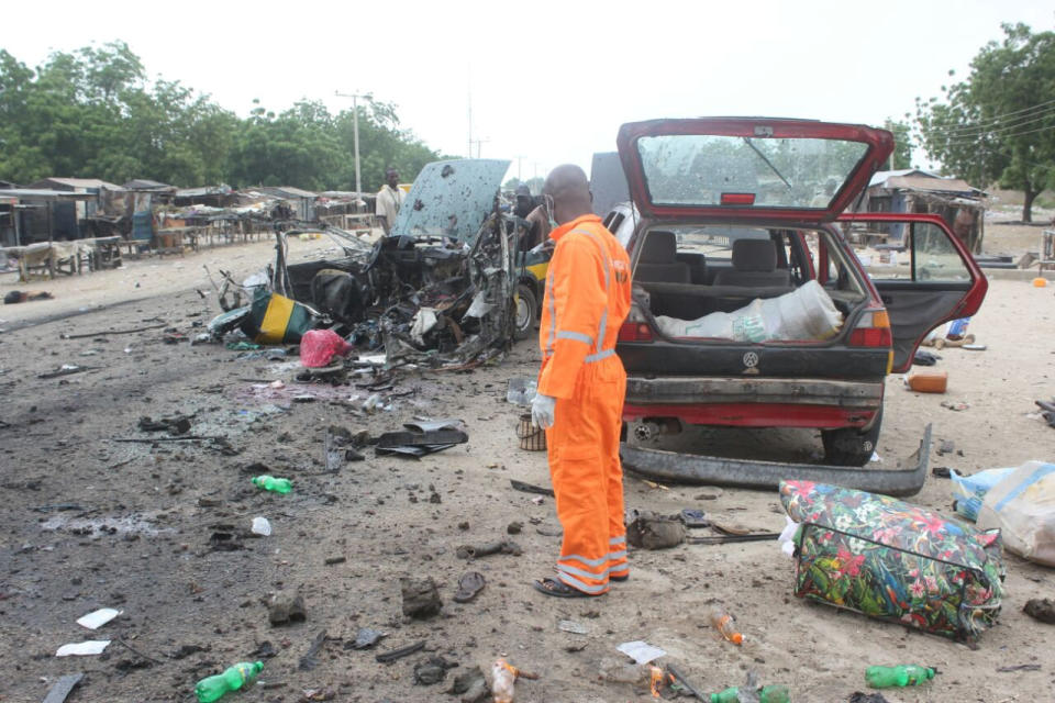 Rescue workers are seen at the scene of a bomb blast at Muna garage along Gamboru Ngala road Maiduguri