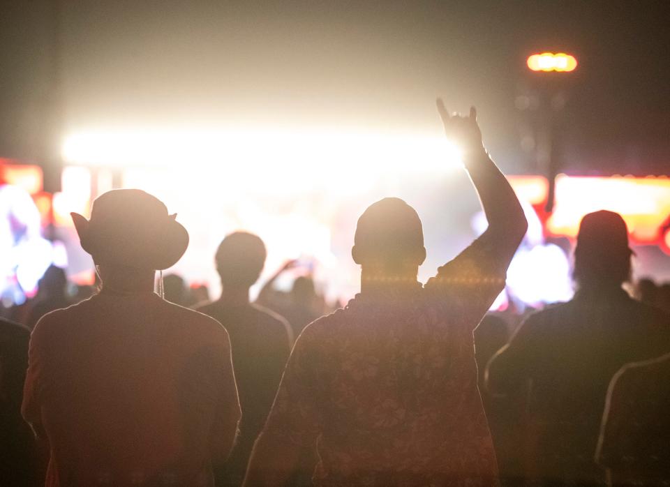 Festivalgoers rock out as AC/DC performs during the Power Trip Music Festival at the Empire Polo Club in Indio, Calif., Saturday, Oct. 7, 2023.