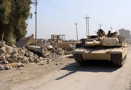 An Iraqi security forces tank is pictured beside a destroyed Mosul's airport building after driving out Islamic State's militants south west Mosul, Iraq February 23, 2017. REUTERS/Zohra Bensemra