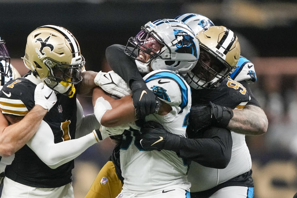 Carolina Panthers running back Chuba Hubbard is tackled by the New Orleans Saints during the second half of an NFL football game in New Orleans, Sunday, Dec. 10, 2023. (AP Photo/Gerald Herbert)