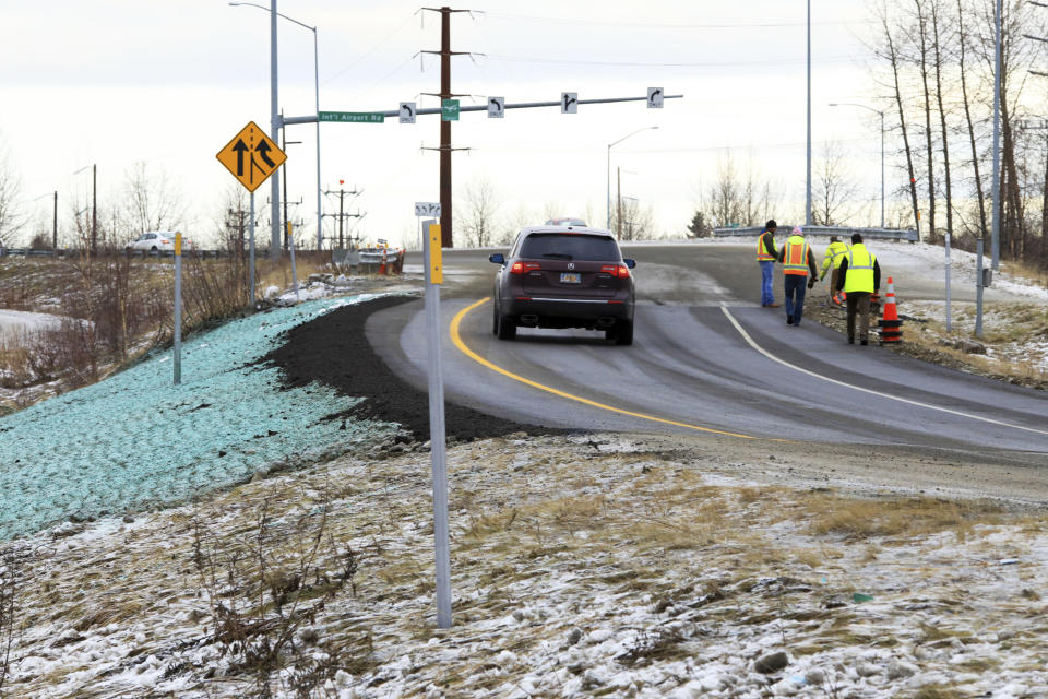 A car ascends a newly repaired off-ramp of Minnesota Drive on Wednesday, Dec. 5, 2018, in Anchorage, Alaska. A massive 7.0 earthquake and its aftershocks rocked buildings and buckled roads Nov. 30, including the road that's a route to Ted Stevens Anchorage International Airport. Alaska transportation officials made rebuilding the ramp a priority. It reopened Tuesday, Dec. 4, and a crew completed shoulder work Wednesday. (AP Photo/Dan Joling)