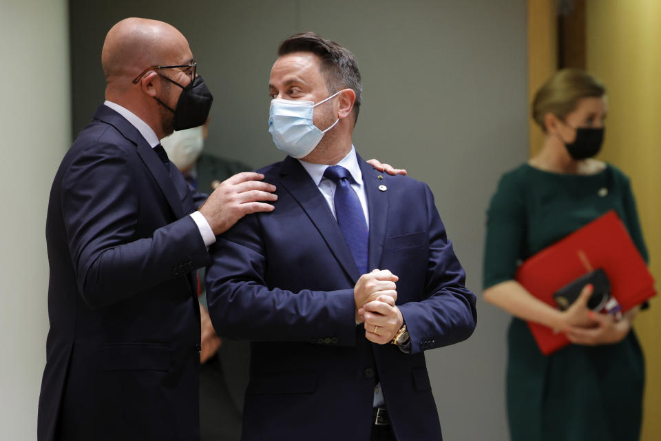 European Council President Charles Michel, left, greets Luxembourg's Prime Minister Xavier Bettel during an EU summit at the European Council building in Brussels, Thursday, June 24, 2021. At their summit in Brussels, EU leaders are set to take stock of coronavirus recovery plans, study ways to improve relations with Russia and Turkey, and insist on the need to develop migration partners with the countries of northern Africa, but a heated exchange over a new LGBT bill in Hungary is also likely. (AP Photo/Olivier Matthys, Pool)