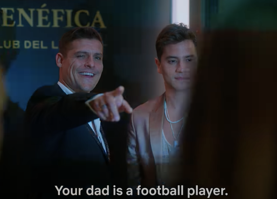 A man with a teenager at an event and the words "Your dad is a football player"
