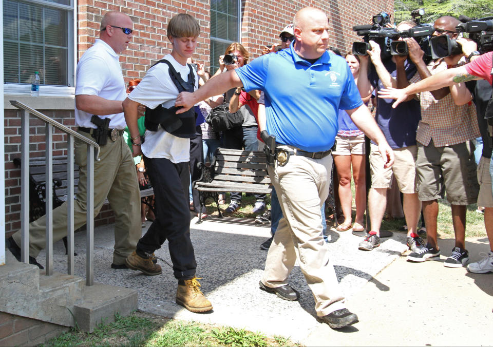 Charleston, S.C., shooting suspect Dylann Storm Roof is escorted from the Sheby Police Department  in Shelby, N.C., Thursday, June 18, 2015. (AP Photo/Ben Earp)