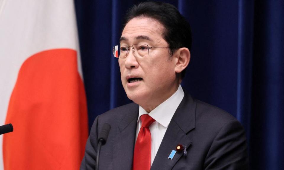 Japan’s prime minister Fumio Kishida delivers a speech, with a Japanese flag hanging beside him