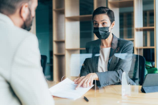 When you're the only one wearing a mask at work, it can feel awkward. But if that's what is best for you and your community, there are mantras to say that can help keep you committed to your decision. (Photo: filadendron via Getty Images)