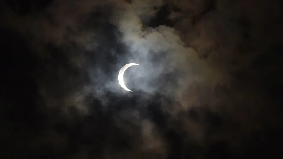 A broken layer of clouds passes below a solar eclipse in Mumbai, India, on December 26, 2019. - Vijayanand Gupta/Hindustan Times/Getty Images