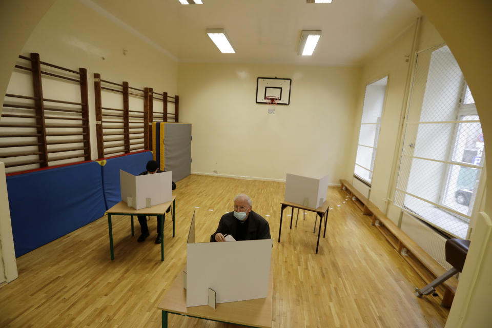 A man prepares his vote during presidential runoff election in Krakow, Poland, Sunday, July 12, 2020. Voting started Sunday in Poland’s razor-blade-close presidential election runoff between the conservative incumbent Andrzej Duda and liberal, pro-European Union Warsaw Mayor Rafal Trzaskowski. (AP Photo/Petr David Josek)