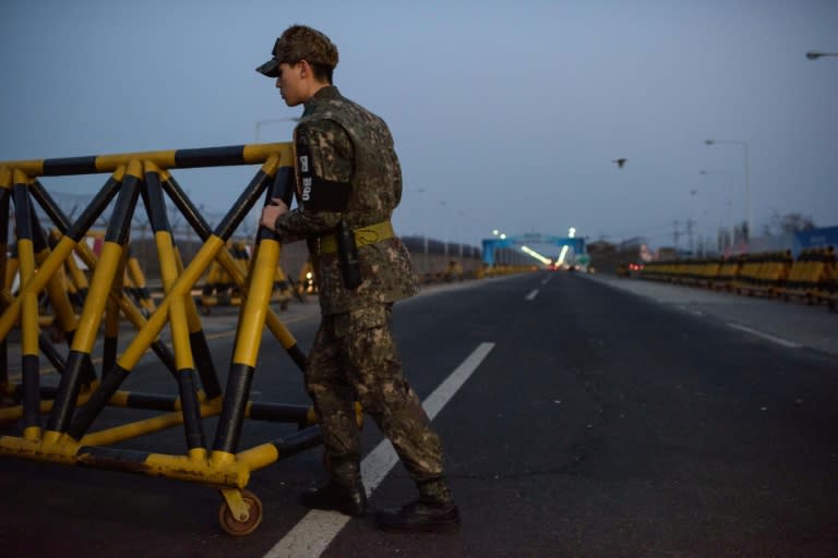 A South Korean soldier pushes a barricade on the Tongil bridge, a checkpoint leading to the Kaesong joint industrial zone, on February 11, 2016