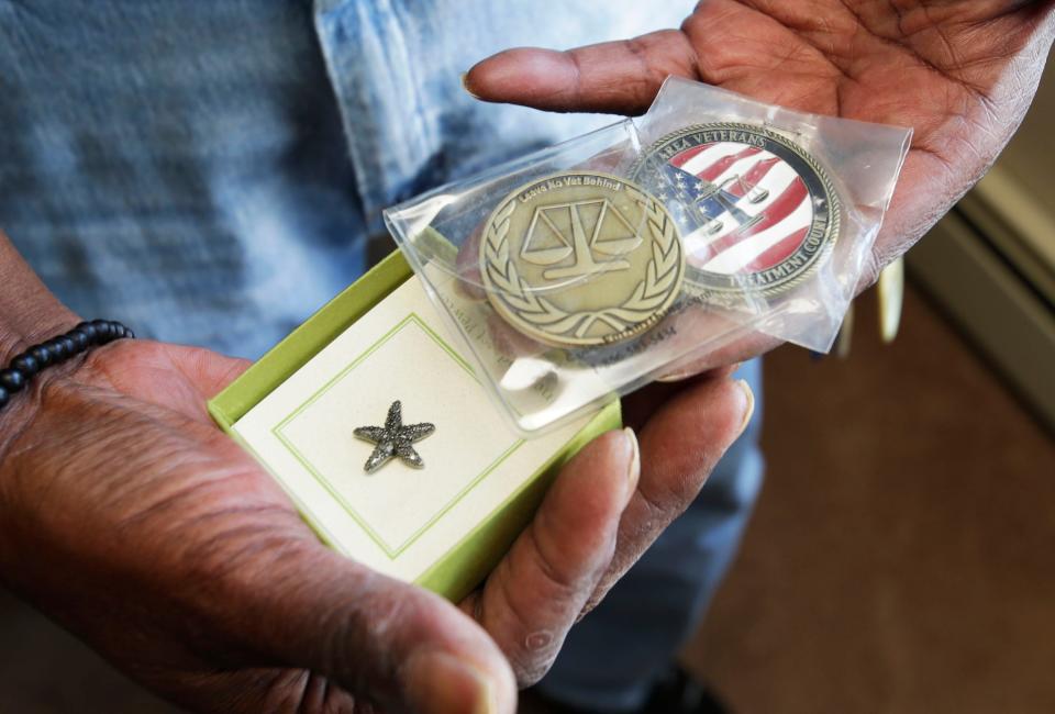 Teddy Henderson, of Sheboygan, displays, Tuesday, March 14, 2023, some of the special medals he has achieved since he went through the veterans court in Sheboygan, Wis.