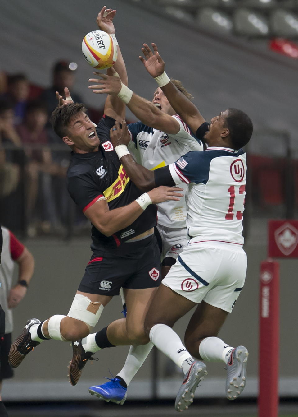 Canada's DTH Van Der Merwe tries to gain control of the ball against United States' Martin Iosefo and Marcel Brache during the first half of a rugby match in Vancouver, British Columbia, Saturday, Sept. 7, 2019. (Jonathan Hayward/The Canadian Press via AP)