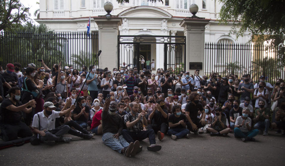 Young artists protest in front of the doors of the Ministry of Culture, in Havana, Cuba, Friday, Nov. 27, 2020. Dozens of Cuban artists demonstrated against the police evicting a group who participated in a hunger strike. (AP Photo/Ismael Francisco)