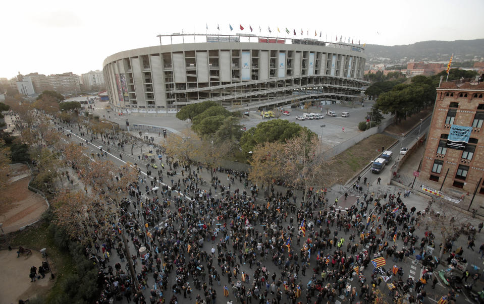 Catalan pro-independence demonstrators gather outside the Camp Nou stadium ahead of a Spanish La Liga soccer match between Barcelona and Real Madrid in Barcelona, Spain, Wednesday, Dec. 18, 2019. Thousands of Catalan separatists are planning to protest around and inside Barcelona's Camp Nou Stadium during Wednesday's match against fierce rival Real Madrid. (AP Photo/Joan Mateu)