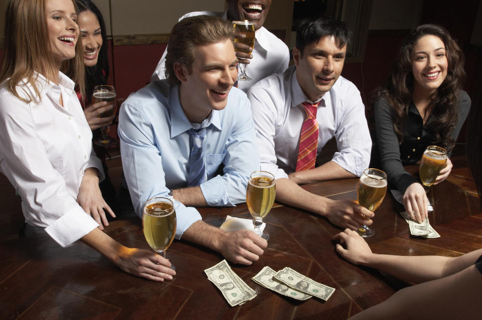 A group of people ordering drinks at a bar.