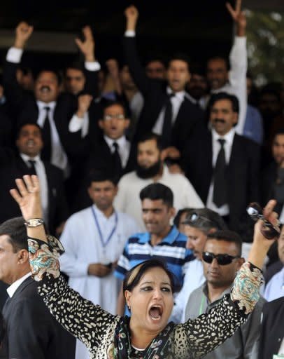 A supporter of Pakistan's Prime Minister Yousuf Raza Gilani demonstrates against the Supreme Court as anti-government lawyers amass behind her in Islamabad. The court disqualified Gilani from office on Tuesday in a stunning move likened to a "judicial coup" that threw the country into fresh turmoil