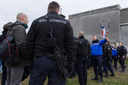 Prison wardens are surrounded by French gendarmes as they block the Lyon-Corbas jail near Lyon during a nationwide protest, France, January 22, 2018. REUTERS/Emmanuel Foudrot