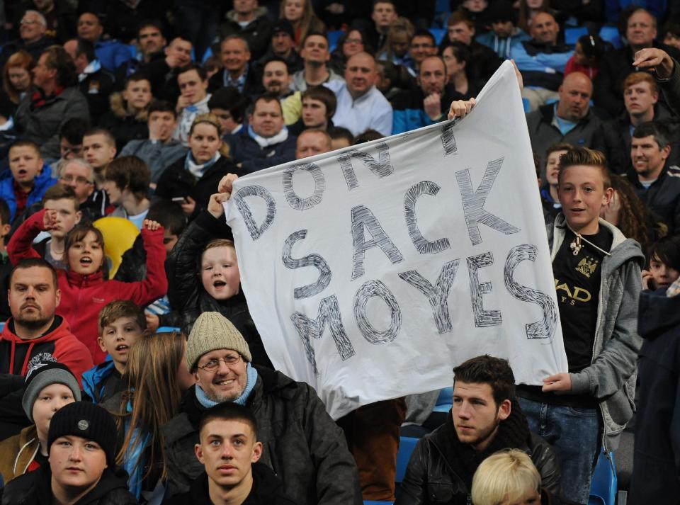 Manchester City supporters display a banner with reference to Manchester United manager David Moyes, during the English Premier League soccer match between Manchester City and West Bromwich at the Etihad Stadium, Manchester, England, Monday, April 21, 2014. (AP Photo/Rui Vieira)