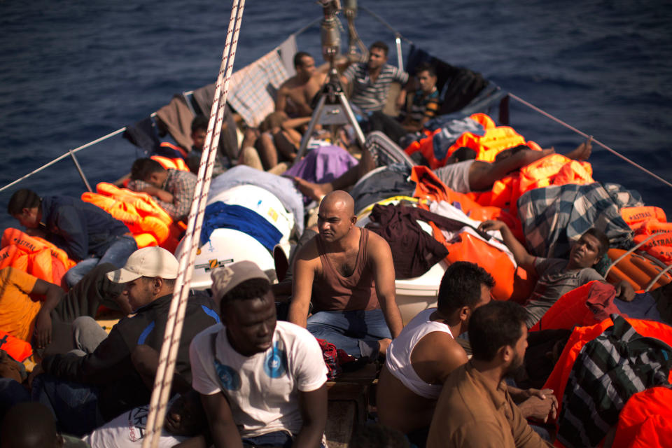 <p>Migrants sit aboard a rescue boat after fleeing Libya, assisted by members of a Spanish NGO, during a rescue operation at the Mediterranean sea, about 25 miles north of Sabratha, Libya, Thursday, Aug. 18, 2016. At least three people have died on Thursday morning during the sinking of a wooden boat full with migrants as they tried to reach the Italian coasts. (AP Photo/Emilio Morenatti) </p>