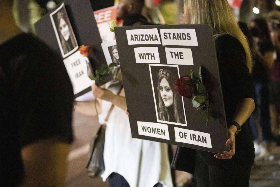 A demonstrator holds a photo of Mahsa Amini at ASU's Tempe campus on Oct. 1, 2022. Amini was a woman who died under mysterious circumstances three days after the Iranian morality police arrested her for not covering all of her hair with a hijab.