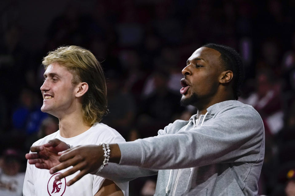 Southern California guard Bronny James, right, celebrates during the first half of an NCAA college basketball game against Cal State Bakersfield, Thursday, Nov. 9, 2023, in Los Angeles. (AP Photo/Ryan Sun)