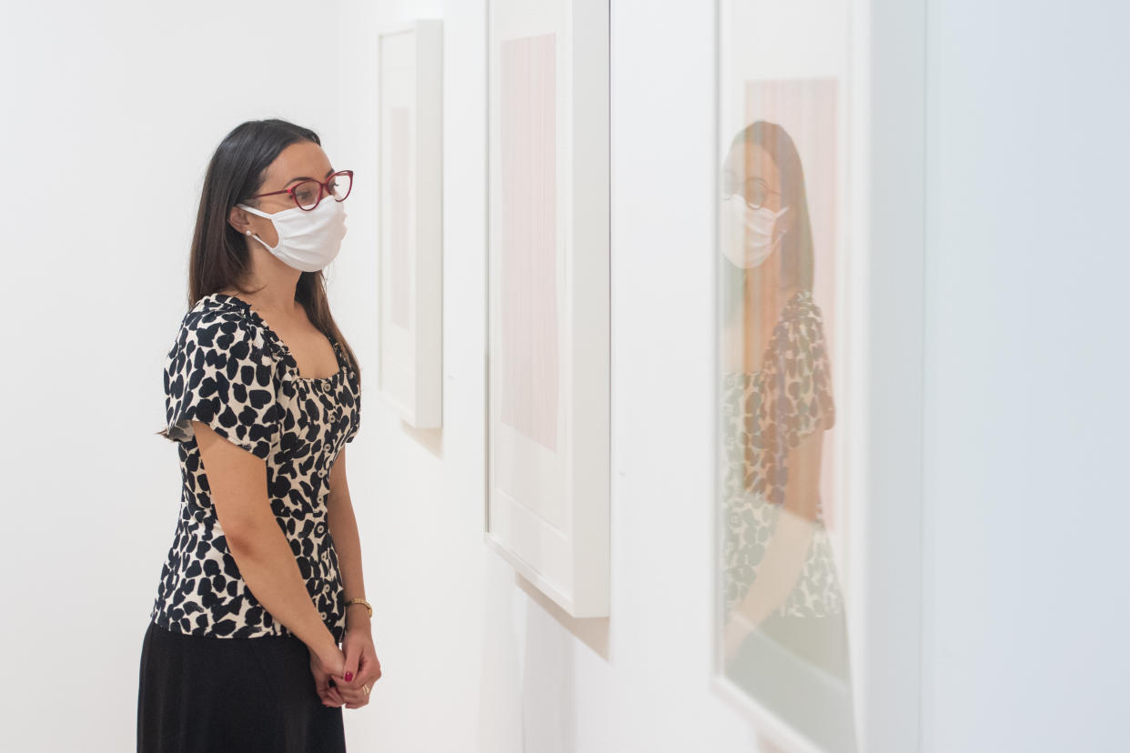 Sara Chan views artworks by Bridget Riley at the David Zwirner modern art gallery in Mayfair, London as non-essential shops in England open their doors to customers for the first time since coronavirus lockdown restrictions were imposed in March. (Photo by Dominic Lipinski/PA Images via Getty Images)