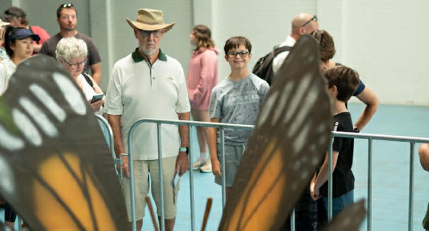 People look at a large sculpture of a butterfly at  Monster Creature World Perth.