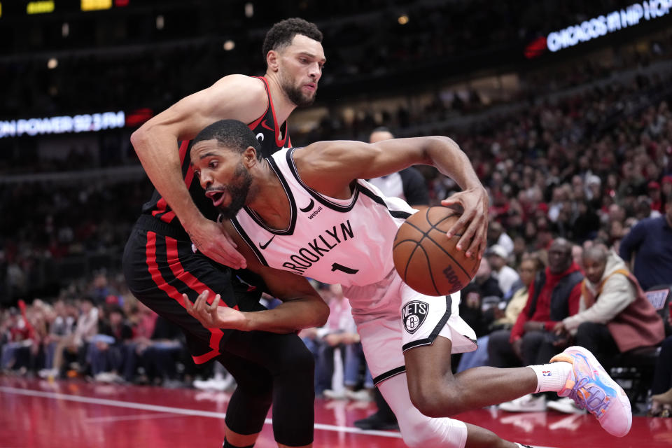 Brooklyn Nets' Mikal Bridges (1) drives to the basket past Chicago Bulls' Zach LaVine, top, during the second half of an NBA in-season tournament basketball game Friday, Nov. 3, 2023, in Chicago. (AP Photo/Charles Rex Arbogast)
