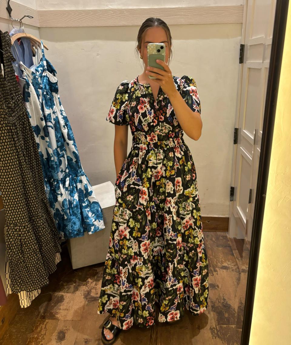 woman taking mirror photo in anthropologie's floral somerset maxi dress, I tried on the viral Somerset dress in dark grey (Photo via Kayla Kuefler).