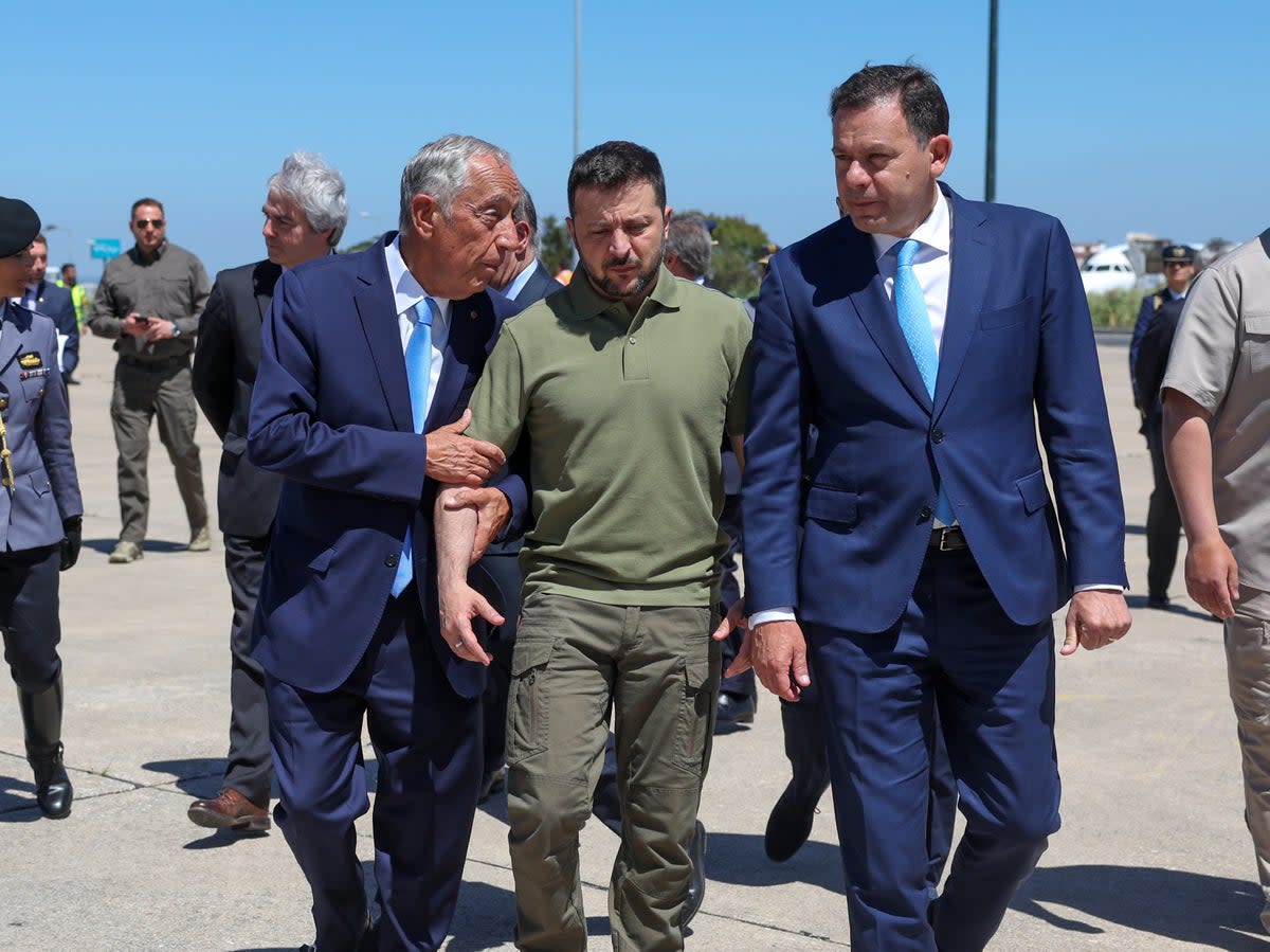 Portuguese head of state Marcelo Rebelo de Sousa, left, and Portuguese prime minister Luis Montenegro, right, welcome Ukraine's President Volodymyr Zelensky, centre, on his arrival at Figo Maduro air base (Getty Images)