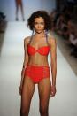 <p>Strappy swimsuits reigned supreme in 2010. Bottoms at the time commonly had at least two strings or straps, if not a woven strap situation much like the model's here.</p>