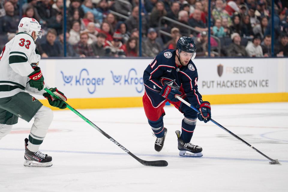 Jan 6, 2024; Columbus, Ohio, USA;
Columbus Blue Jackets center Adam Fantilli (11) prepares to pass the puck around Minnesota Wild defenseman Alex Goligoski (33) during the first period of their game on Saturday, Jan. 6, 2024 at Nationwide Arena.