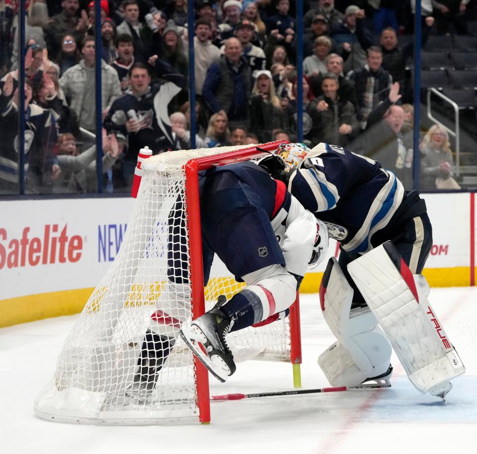 Dec. 201, 2023; Columbus, Ohio, USA; 
Washington Capitals right wing Tom Wilson (43) and Columbus Blue Jackets goaltender Elvis Merzlikins (90) fight in the goal during overtime at Nationwide Arena on Thursday.