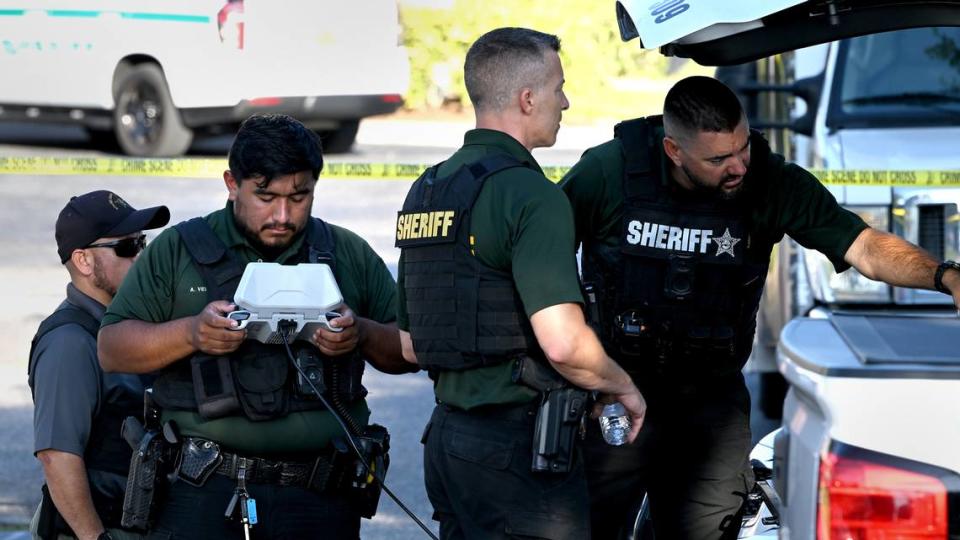 Law enforcement personnel investigate the scene of a shooting that happened around 3:30 a.m. Friday, May 24, 2024. The Manatee County Sheriff’s Office says Sean Calcutti is charged with attempted murder after he tried to break into a nursing home and shot a deputy in the arm.