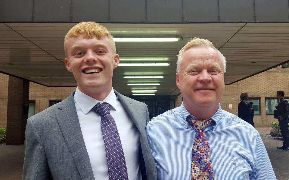 Douglas Vallender with his son Jack, outside Southwark Crown Court, London, after being found not guilty of stealing eight bottles of champagne worth £348  - PA