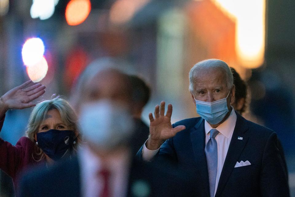 President-elect Joe Biden and his wife Jill Biden wave as they leave the The Queen theater, Tuesday, Nov. 24, 2020, in Wilmington, Delaware.