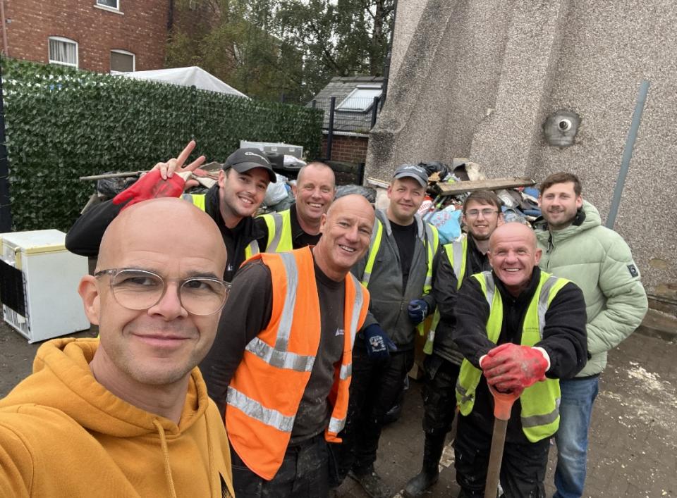 Pastor Paul Hollingworth standing with people from the local council during the clean-up following heavy flooding 