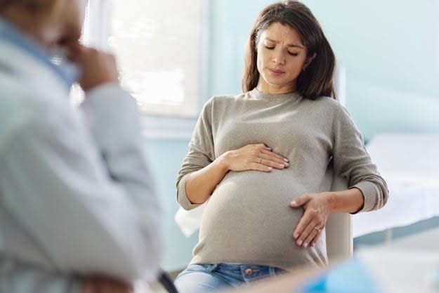 Worried pregnant woman having an appointment with her gynecologist in the office