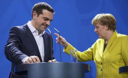 German Chancellor Angela Merkel and Greek Prime Minister Alexis Tsipras leave after addressing a news conference following talks at the Chancellery in Berlin March 23, 2015. REUTERS/Hannibal Hanschke